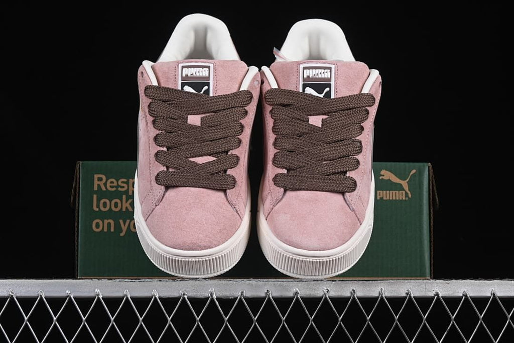 Front view of the pair showing the pink uppers and dark brown laces.
