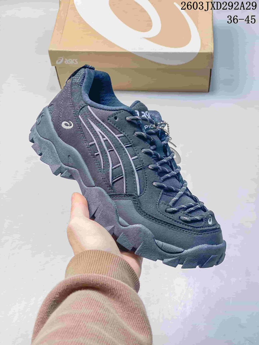 Angled side view of the dark grey sneaker