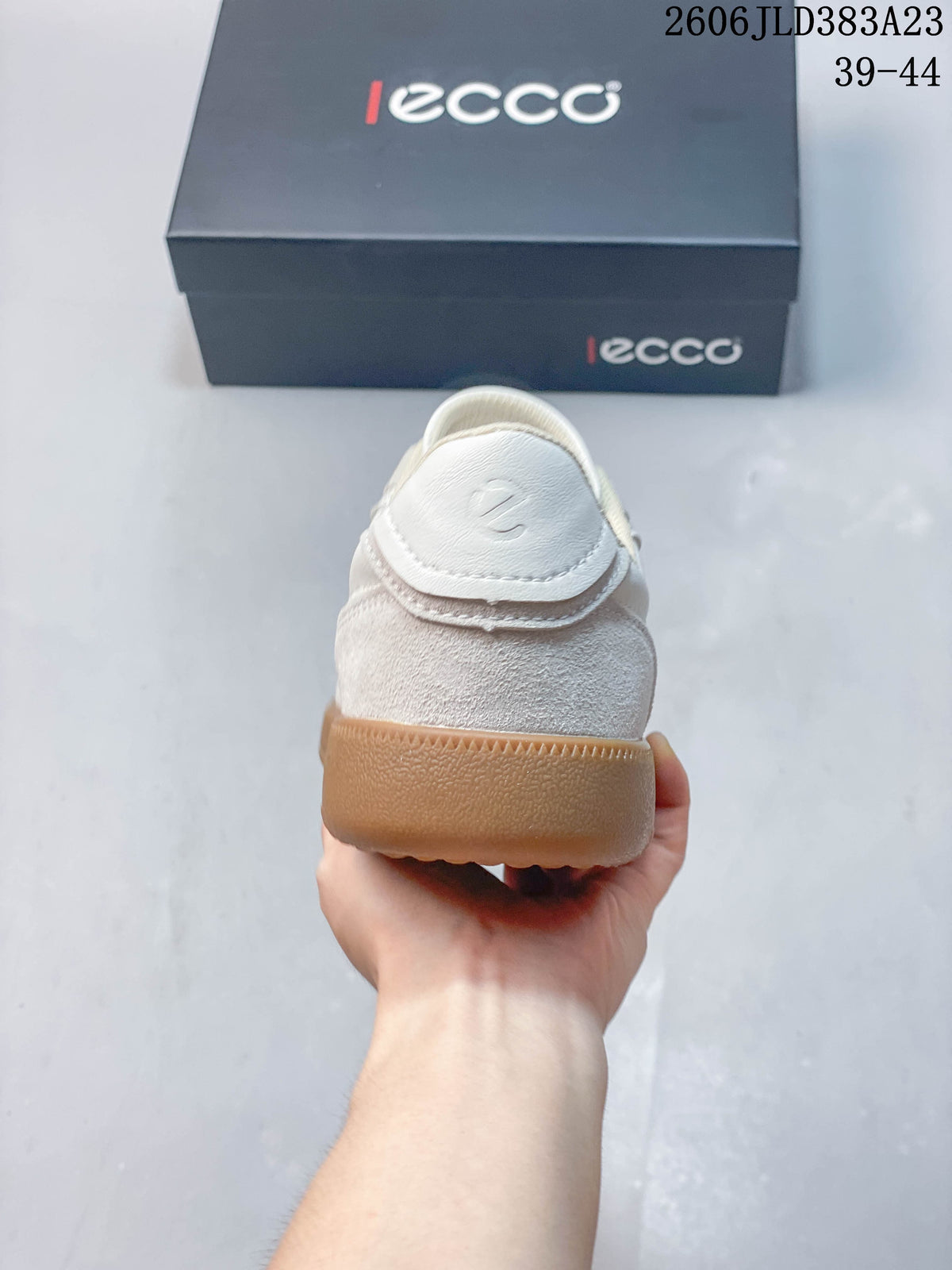 Rear view of the sneaker showing its heel panel and gum-colored sole