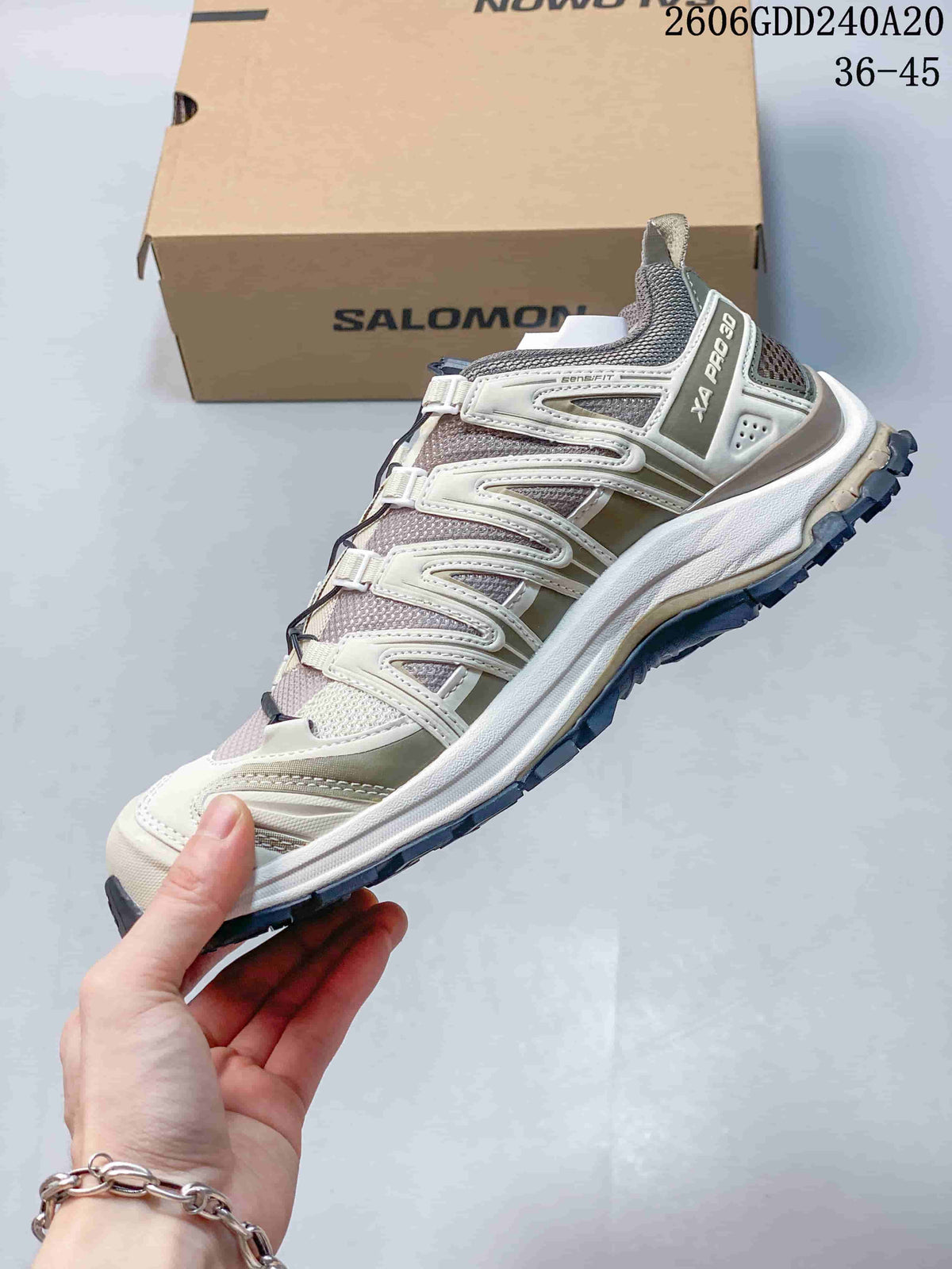 Side view of a light-colored XA Pro 3D shoe with quick-lace fastening.