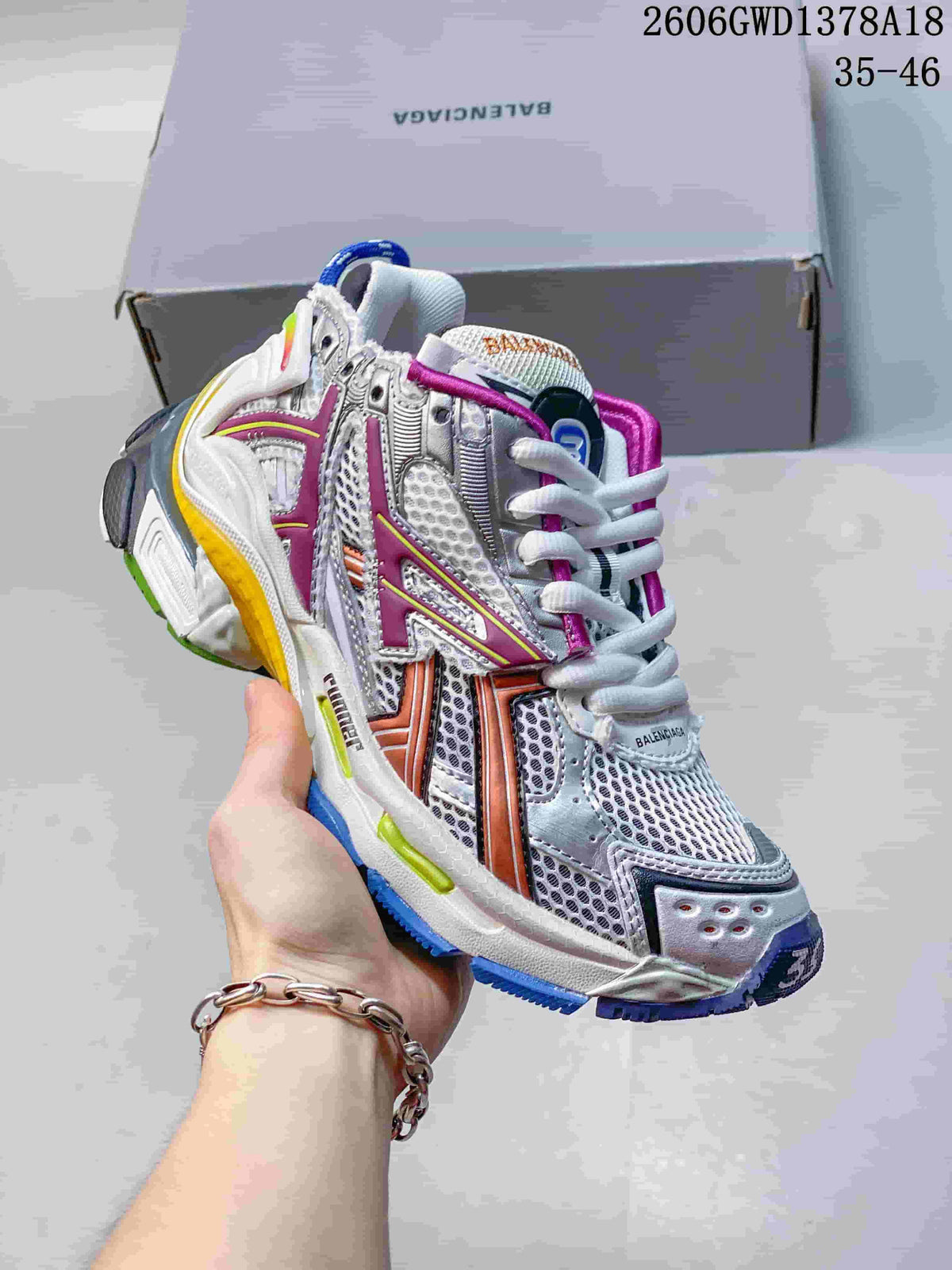 Angled side view of a silver Balenciaga Runner sneaker with mesh panels and multicolor details