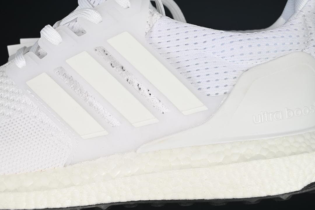 Close-up of the side stripes, knit upper and textured midsole.