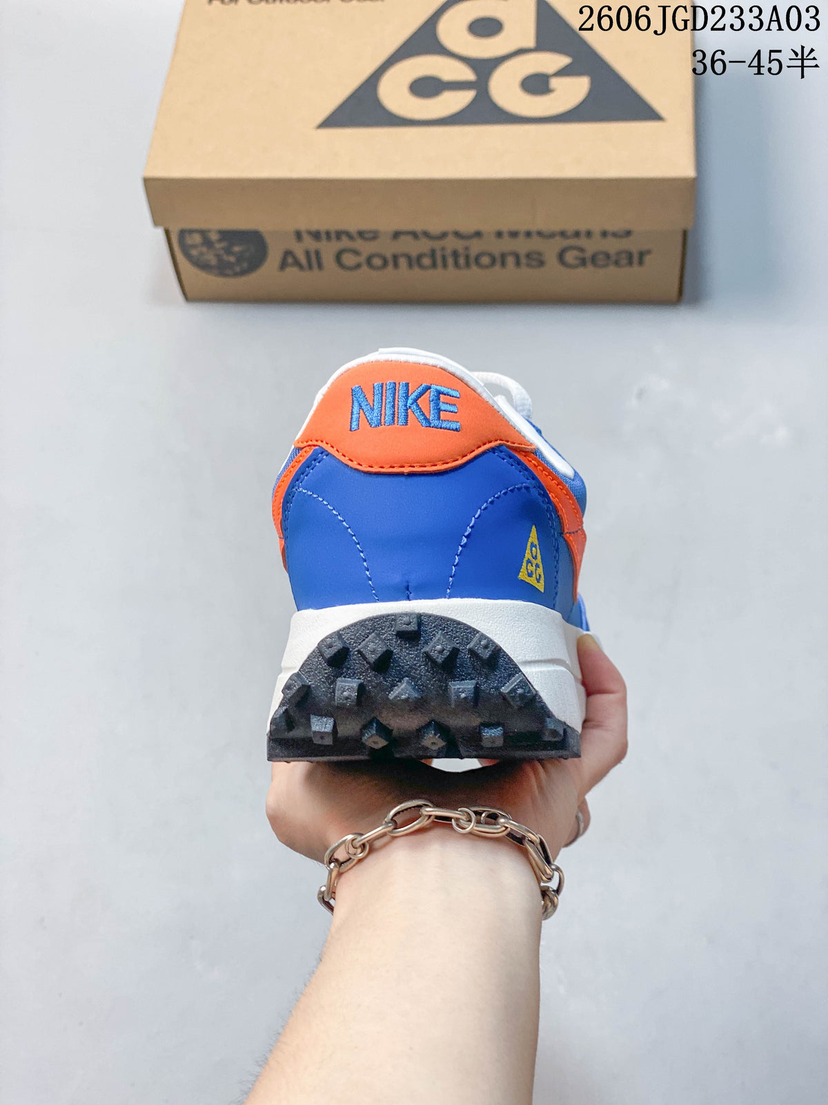 Rear view showing the blue and orange heel and lugged outsole