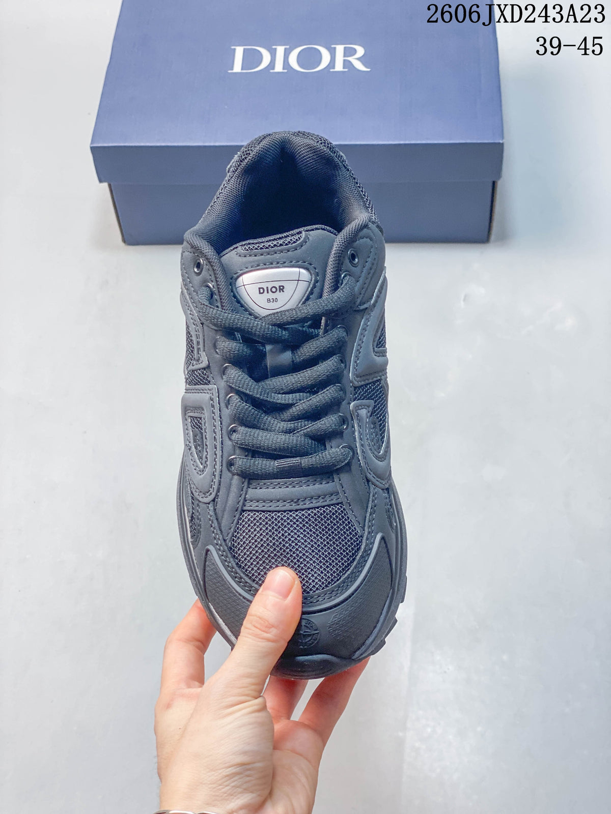 Front view of a charcoal gray lace-up sneaker with mesh panels