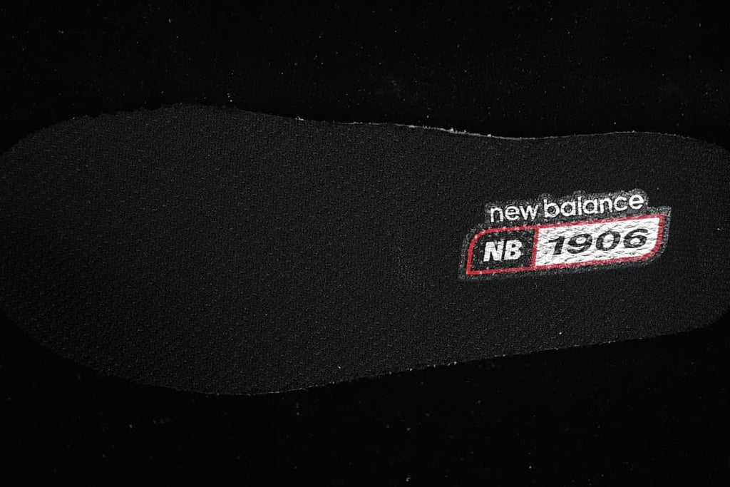 Close-up of an insole marked New Balance 1906R.