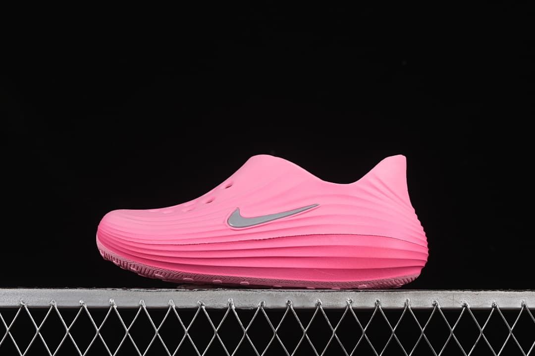 Side view of a bright pink Nike ReactX Rejuven8 clog with silver-tone Swoosh accent.