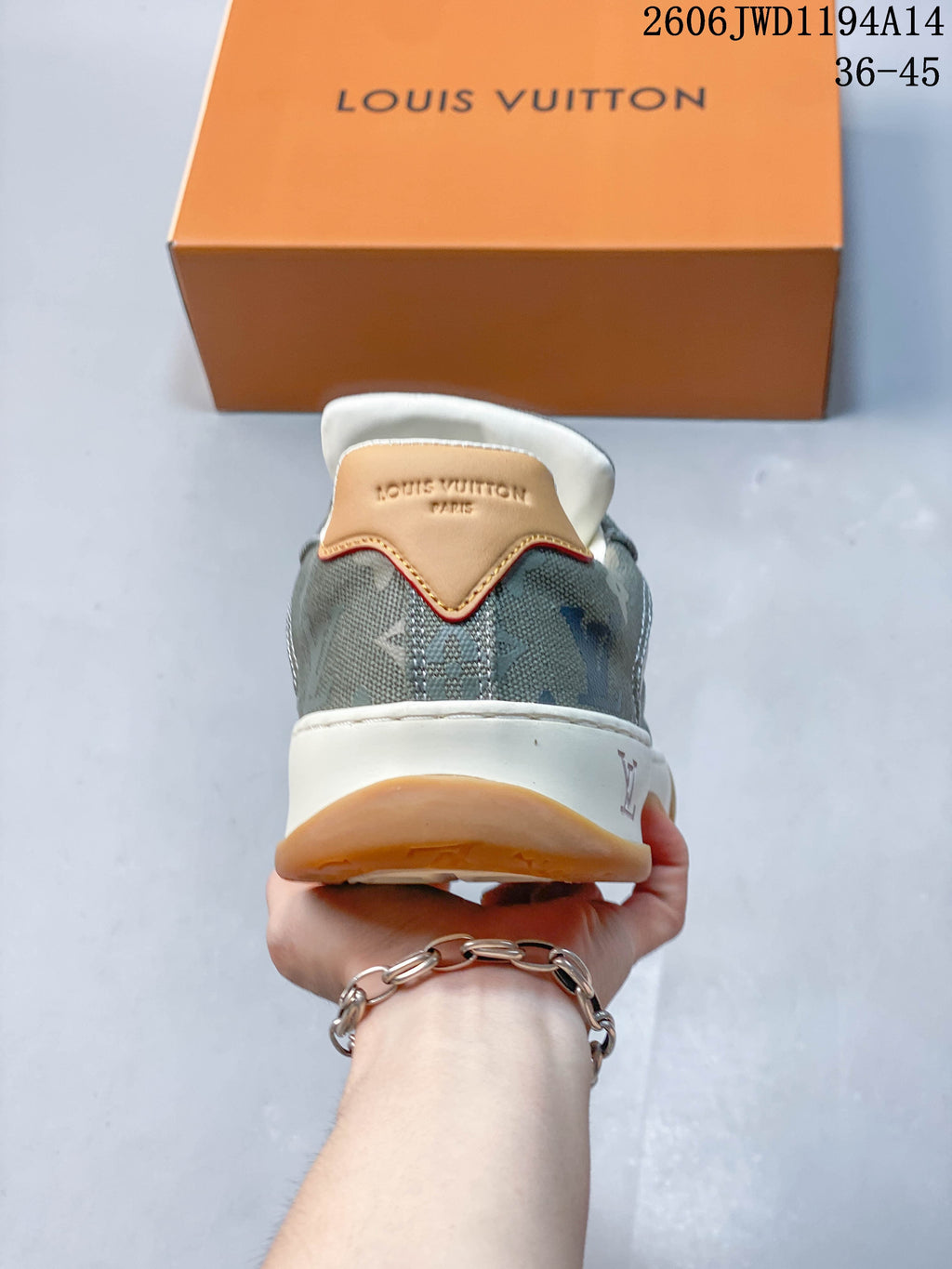 Rear view of the sneaker showing the patterned heel, tan heel tab, and white midsole.
