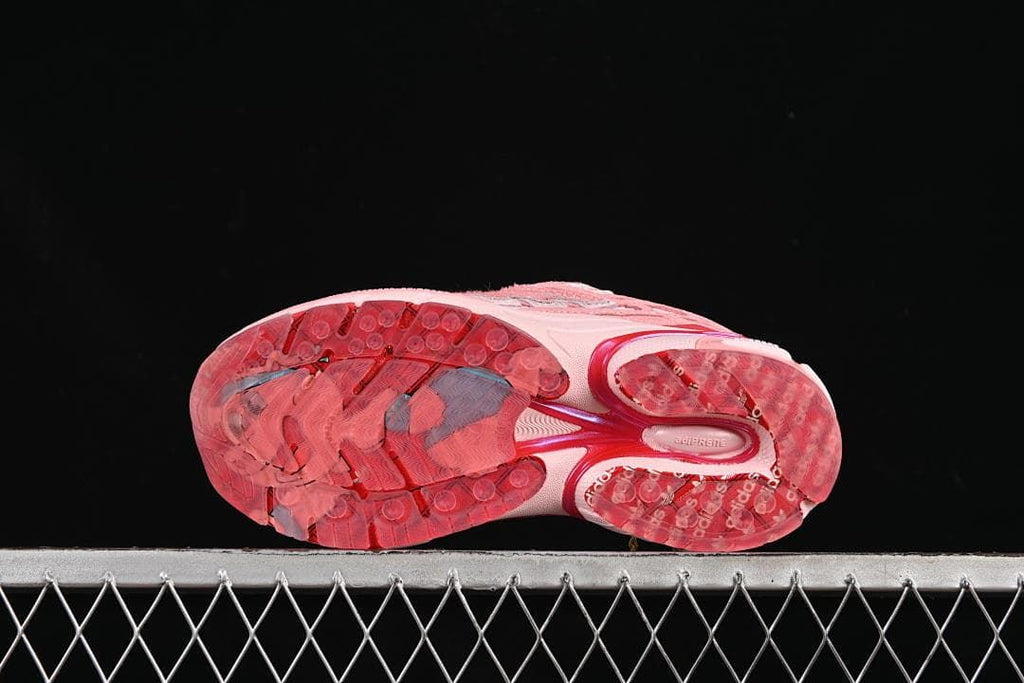 Underside view showing the patterned red outsole.