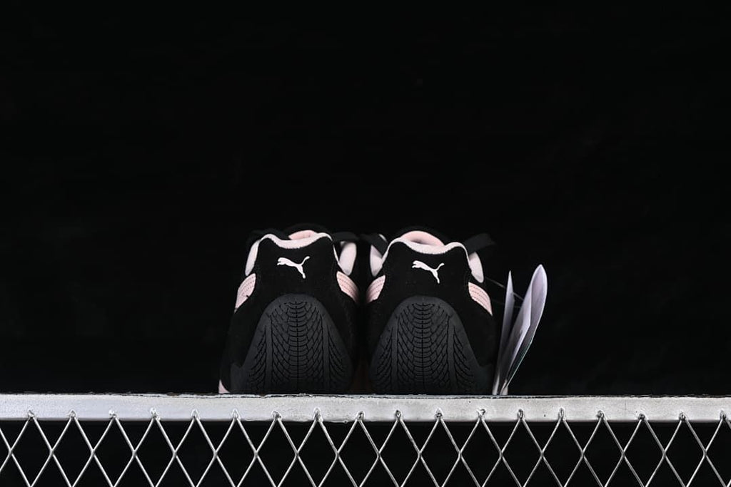 Rear view of both shoes showing their heels and tread patterns.