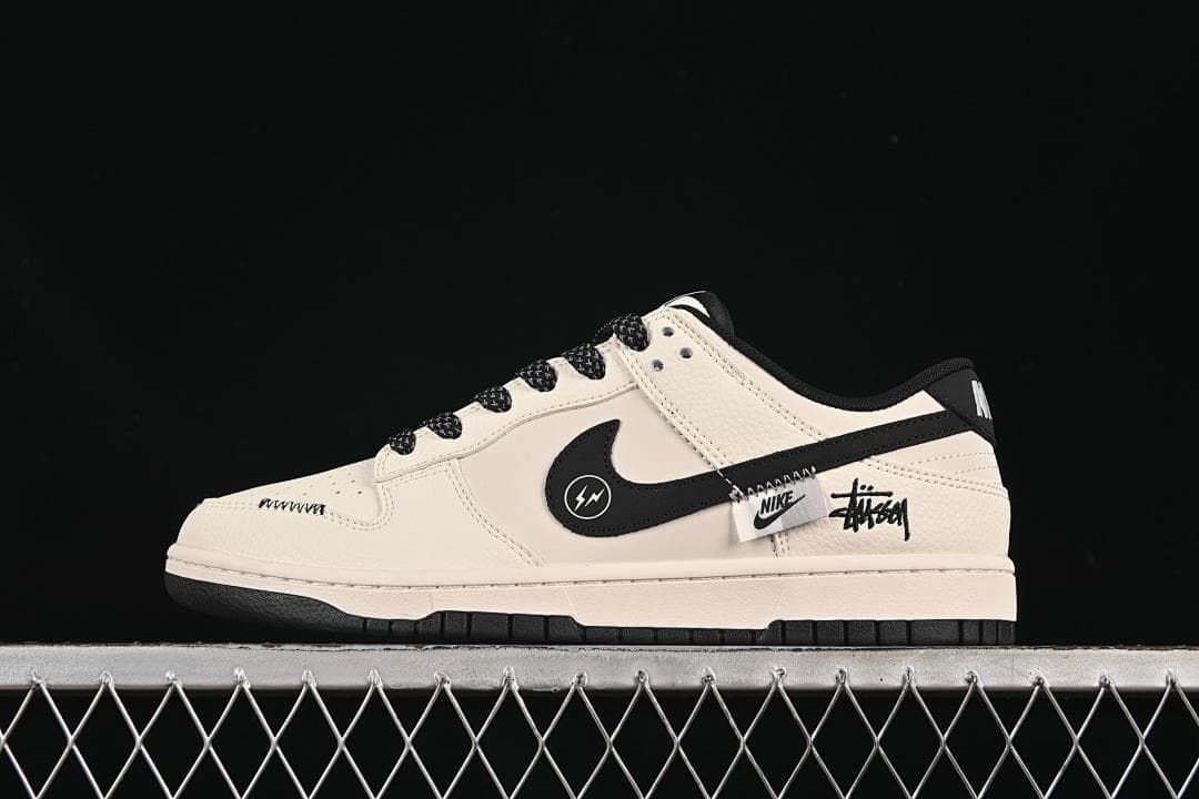 Side view of a cream and black low-top sneaker with graphic side accents