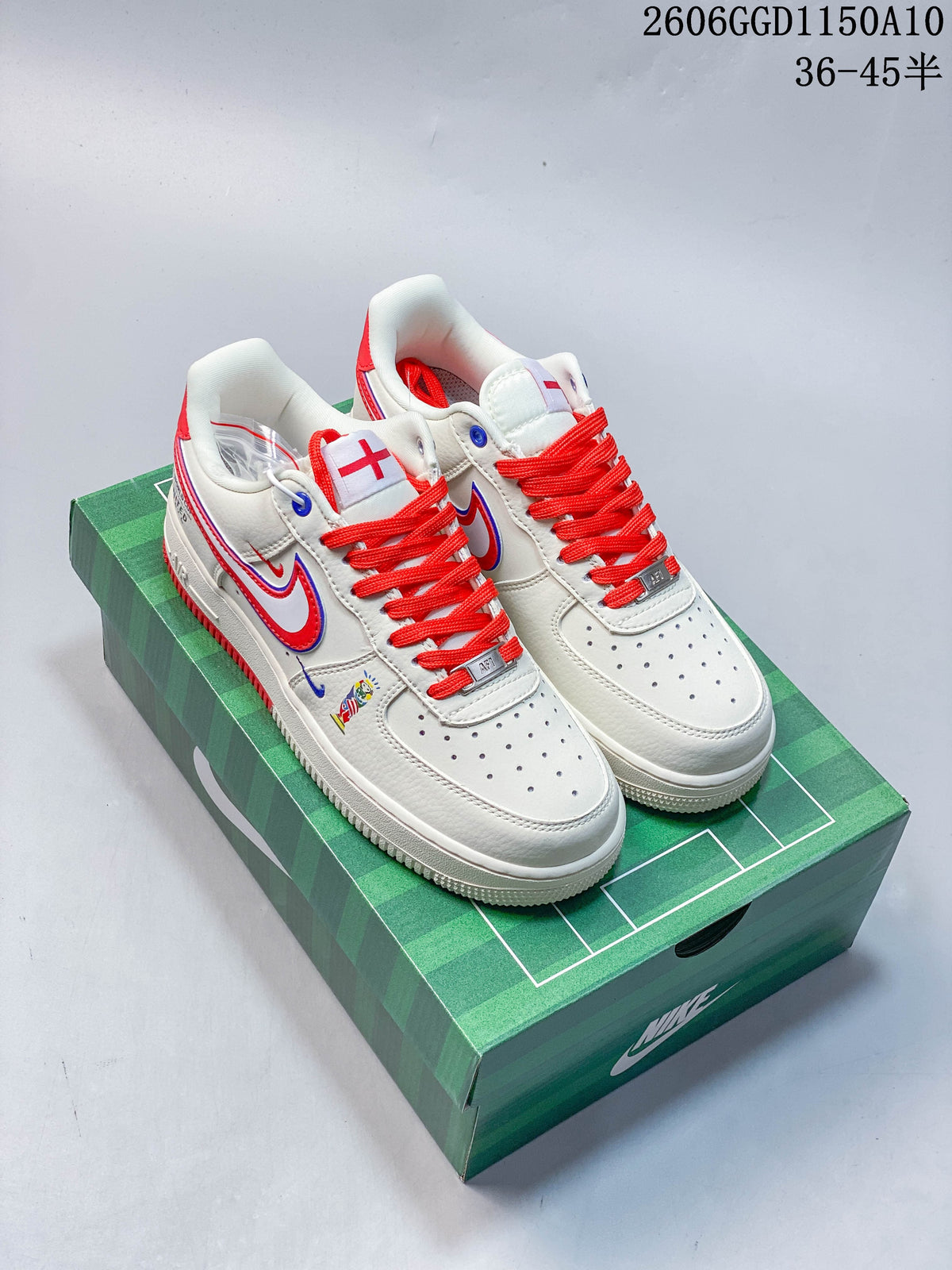 Pair of off-white low-top sneakers with red laces and blue-and-red side detailing on a green box