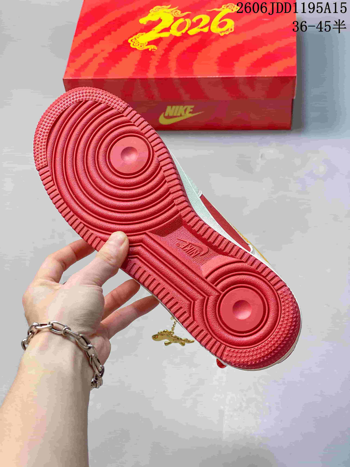 Red outsole of the Nike Air Force 1 Low beside a red 2026-themed box