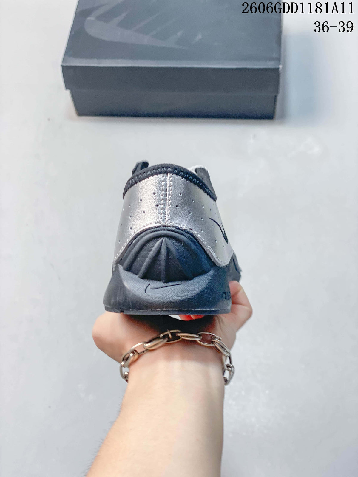 Rear view of the sneaker with a silver heel panel and dark heel counter.