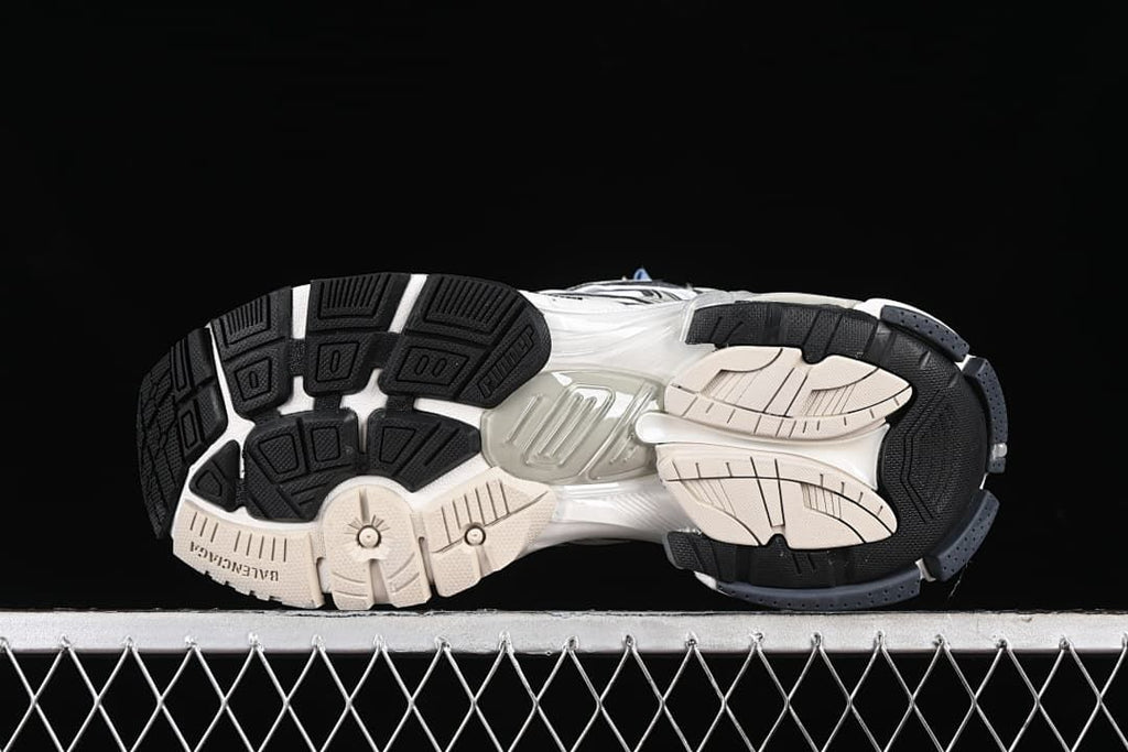 Underside view showing the segmented black, white and beige outsole.