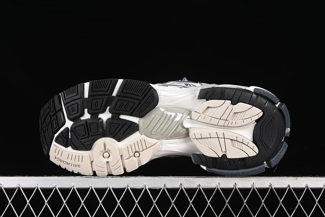 Underside view showing the segmented black, white and beige outsole.