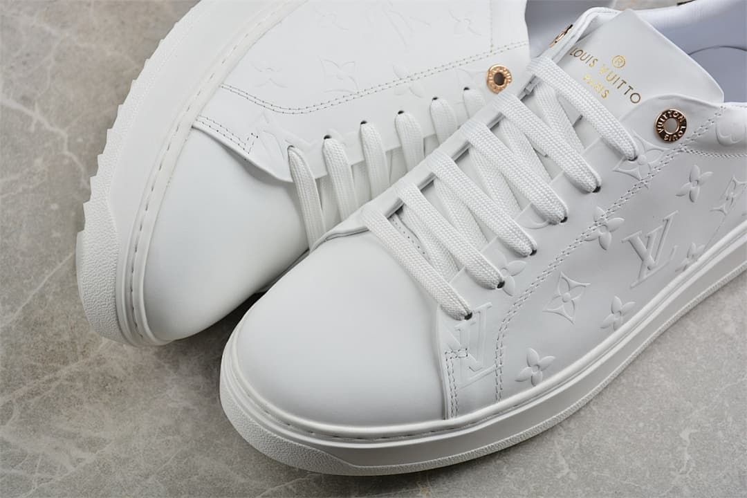 Close-up of the white embossed upper and lace-up toe