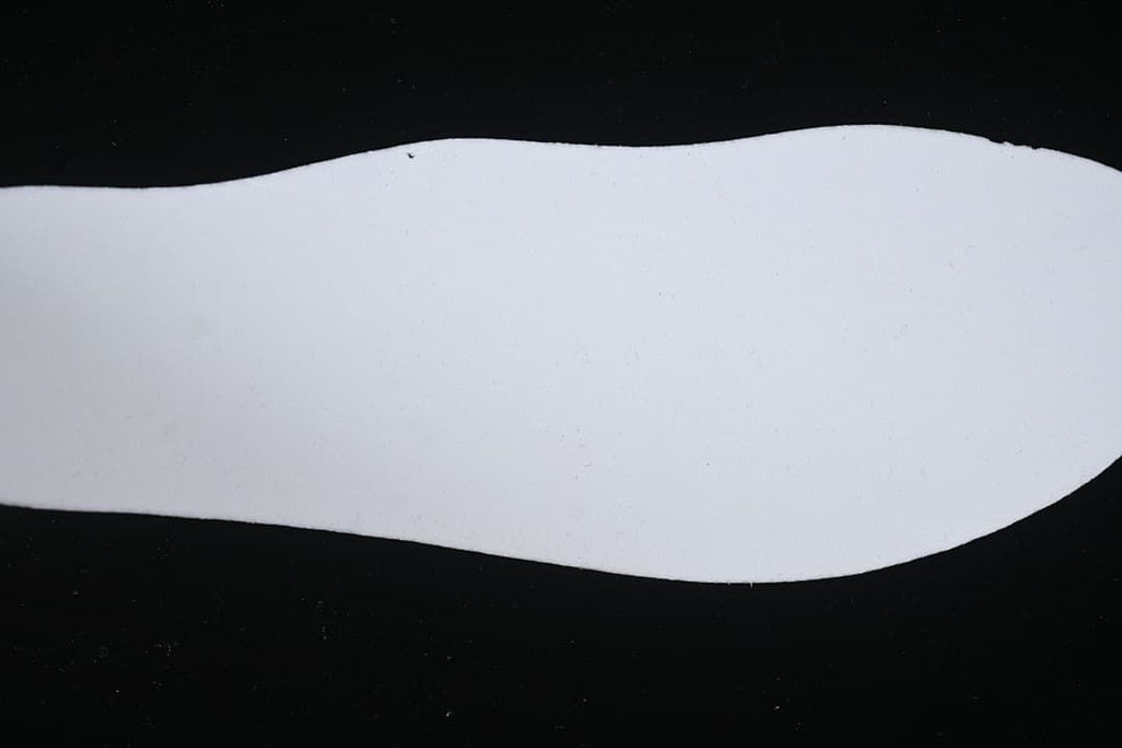 White shoe insert shown against a dark background