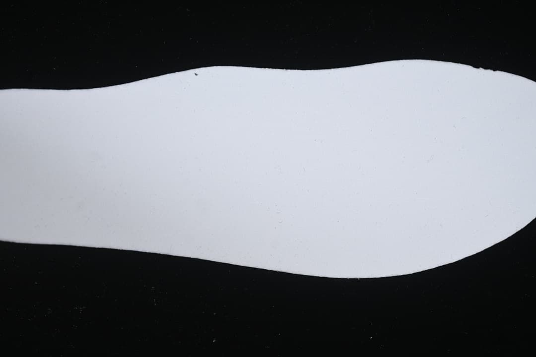 White shoe insert shown against a dark background