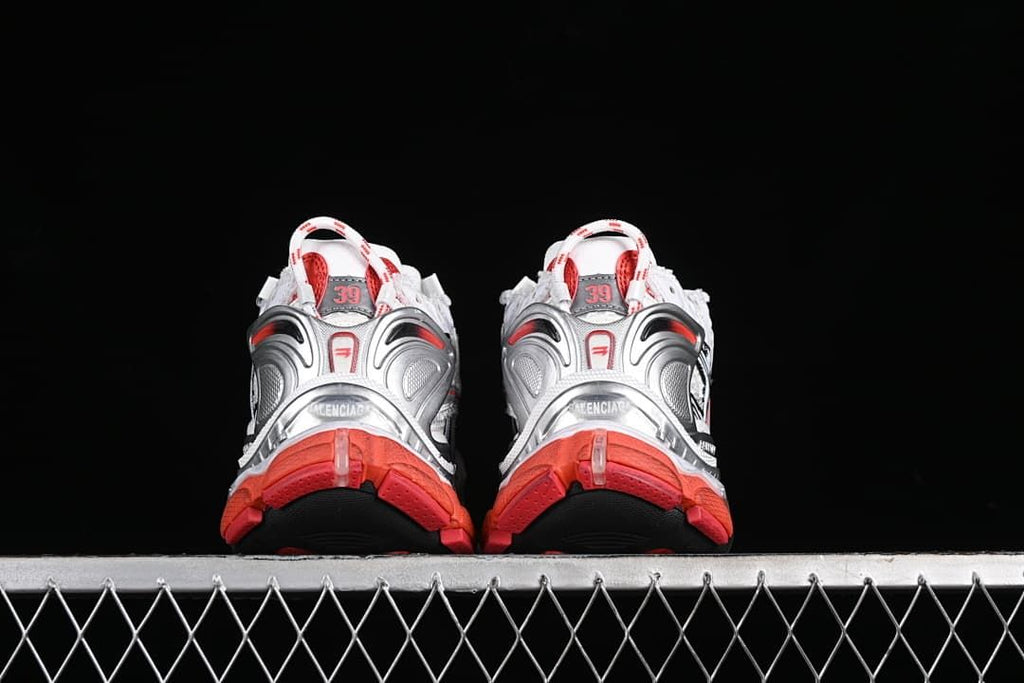Rear view of both sneakers showing silver-toned heel details and red outsole sections.