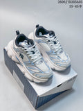 Pair of white MLB Winner chunky sneakers with silver and light blue details, shown on the box.