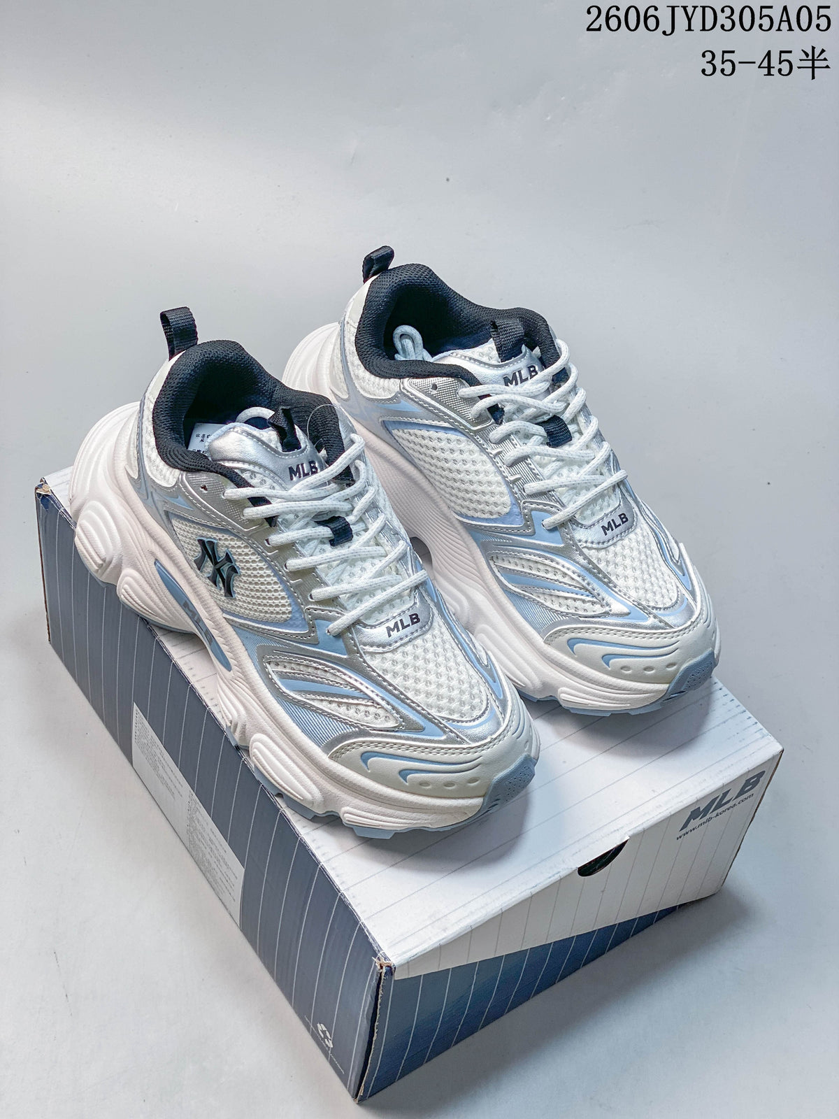 Pair of white MLB Winner chunky sneakers with silver and light blue details, shown on the box.