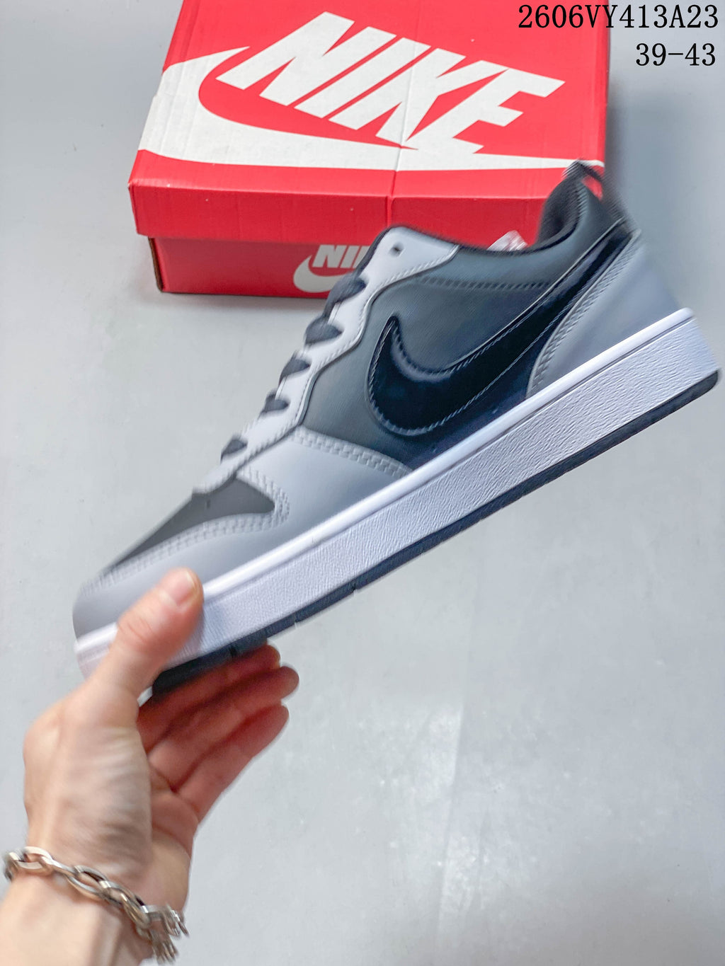 Side view of a gray and black NikeCourt Borough 2 low-top sneaker