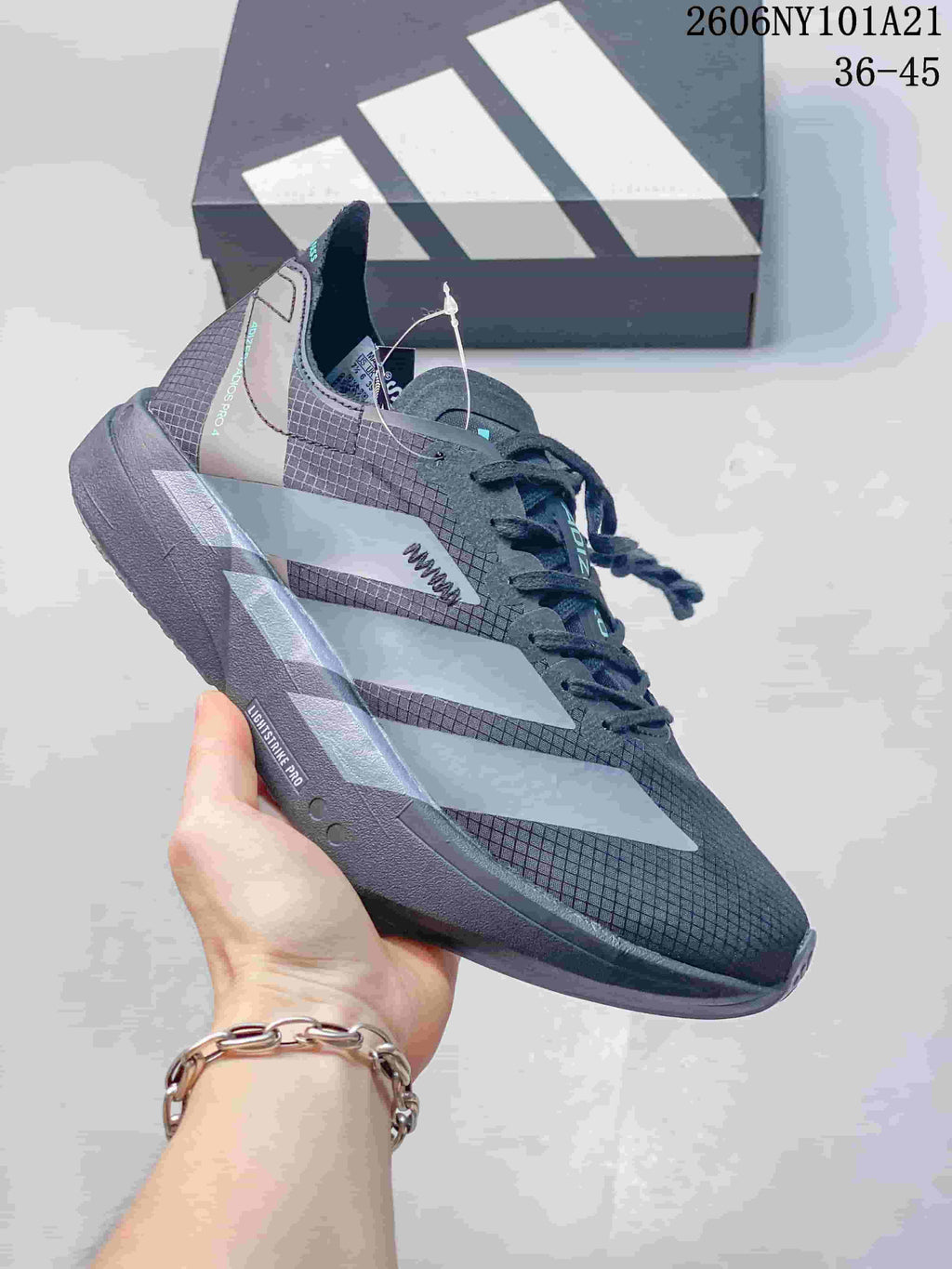 Dark gray Adidas running shoe with pale side stripes and Lightstrike Pro sole; image text shows 36–45.