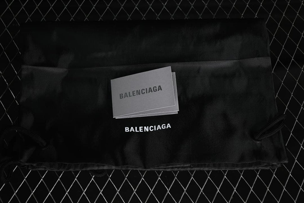 Black dust bag and cards bearing Balenciaga branding