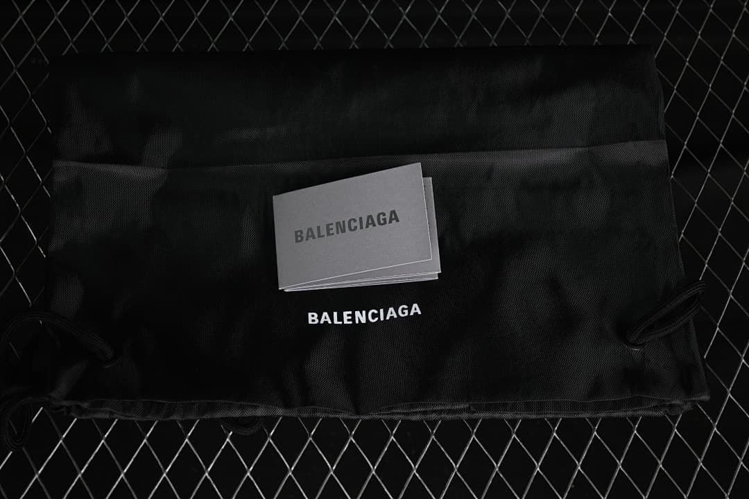 Black dust bag and cards bearing Balenciaga branding