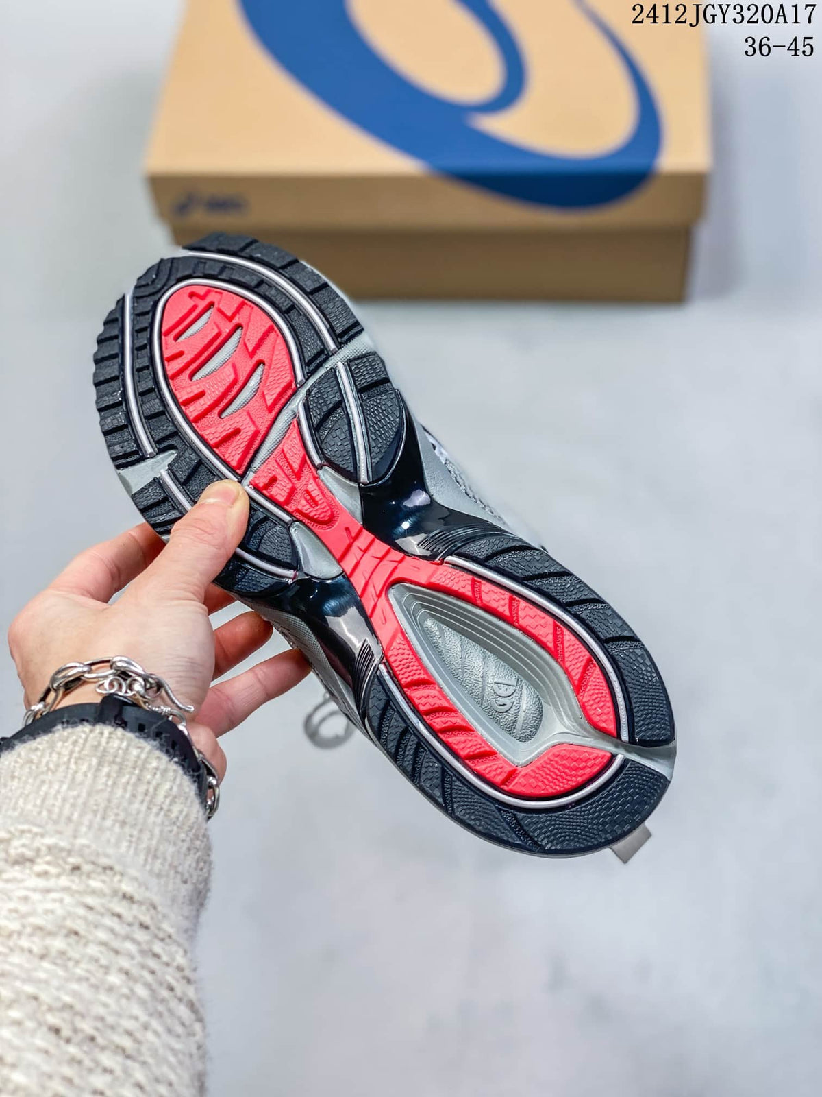 Underside of a sneaker showing a segmented black and red outsole