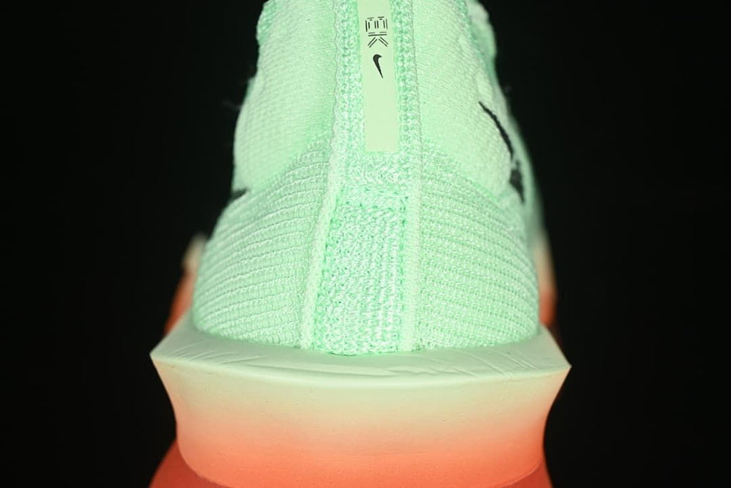 Rear view showing the knit-look heel and coral-toned sole