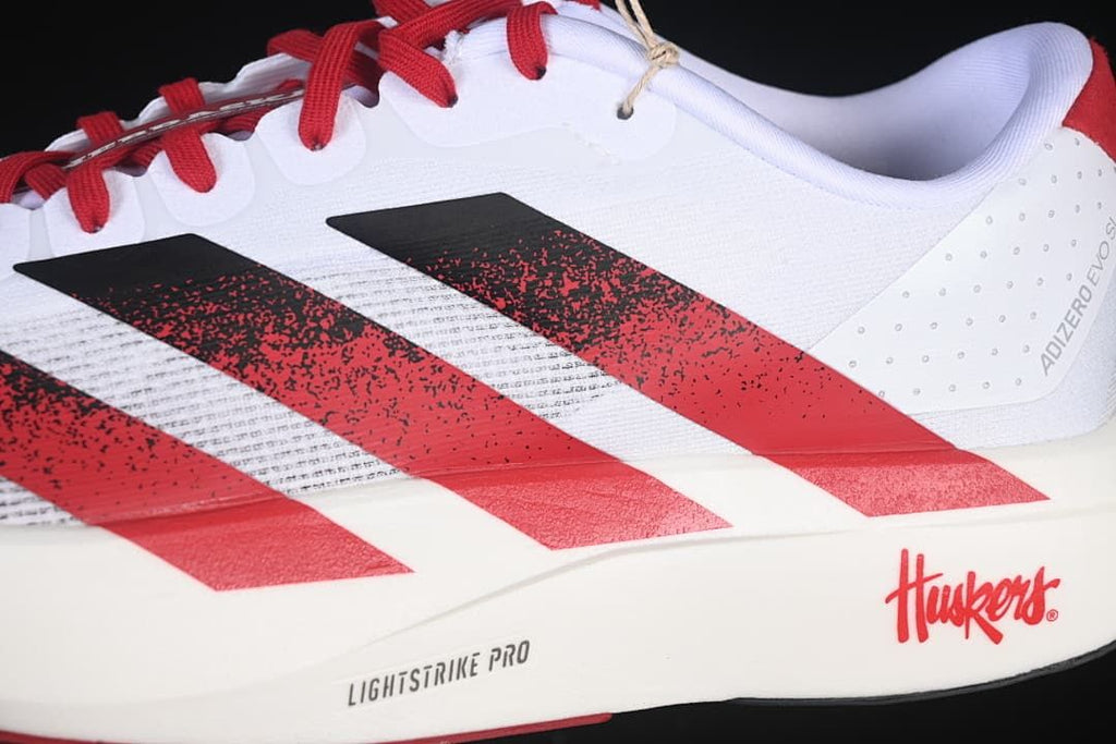 Close-up of black and red side stripes, Nebraska graphics, and midsole lettering