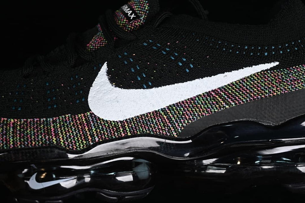 Close-up of the white Swoosh, multicolor knit trim and air-cushion sole