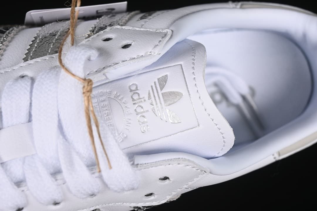 Close-up of the adidas tongue label and white laces