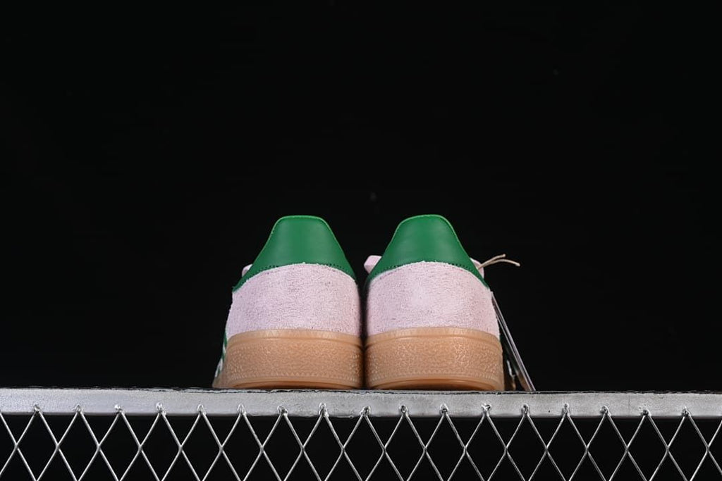 Rear view of the pair showing green heel details and gum soles