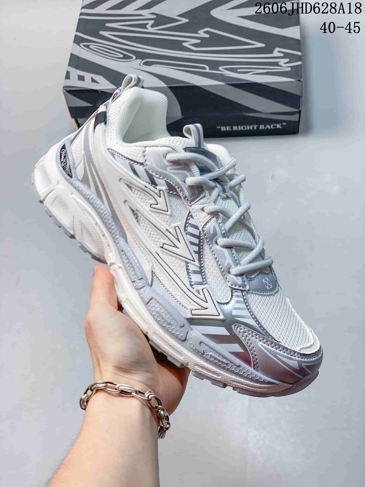 Angled close-up of the white and silver sneaker’s side detailing