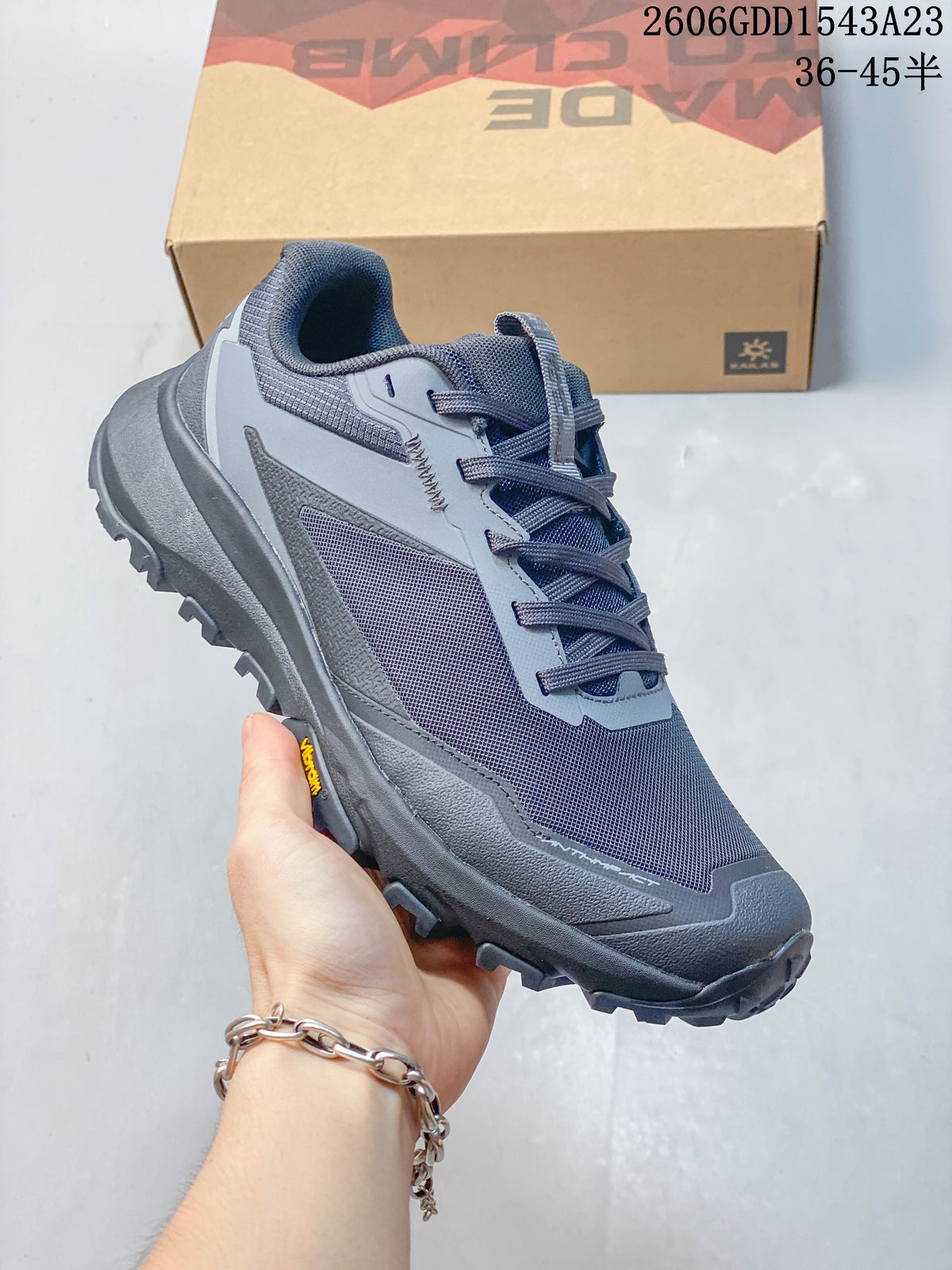Angled side view of gray Kailas trail running shoe