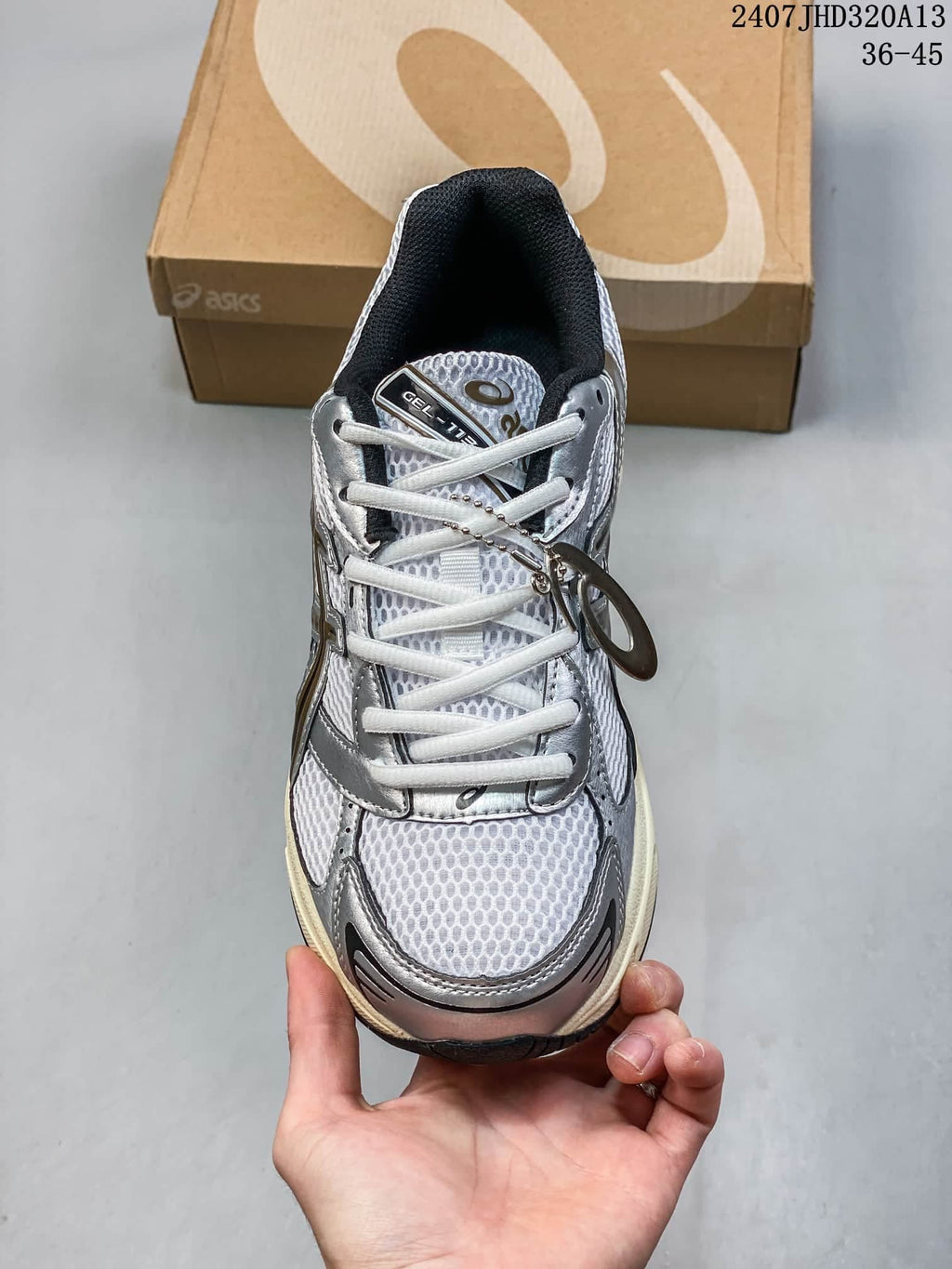 Front view of the ASICS GEL-1130 sneaker with white laces and mesh-look panels