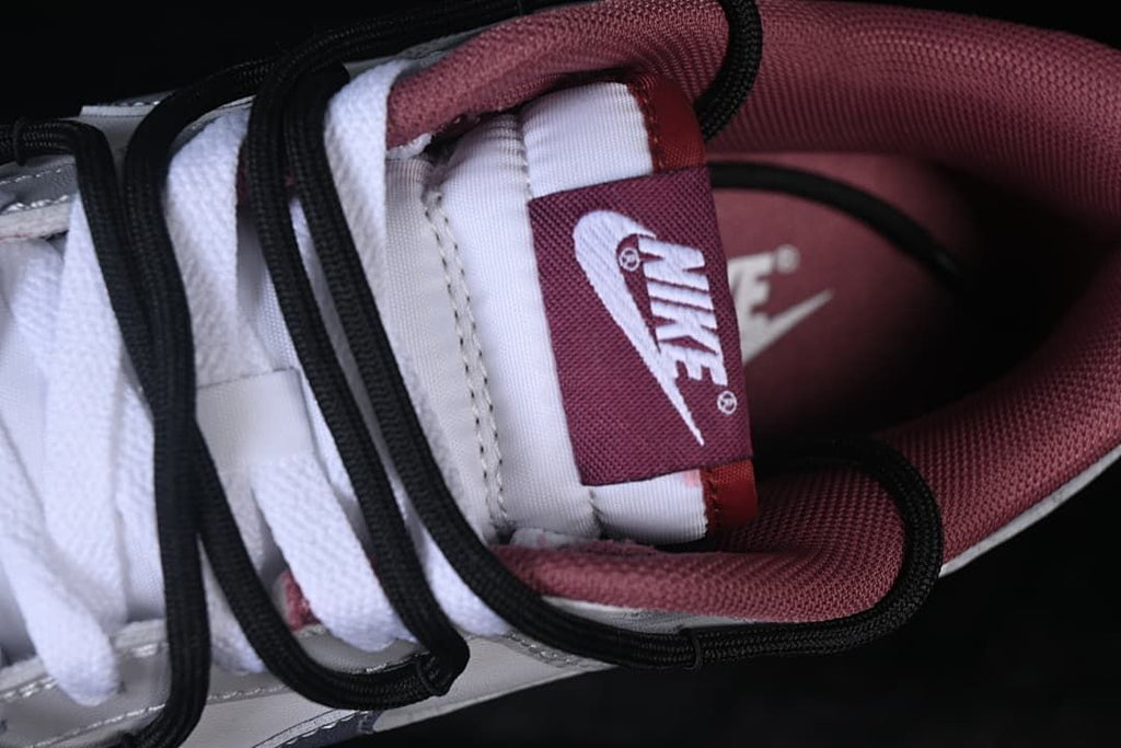 Close-up of tongue label, white laces, and burgundy lining