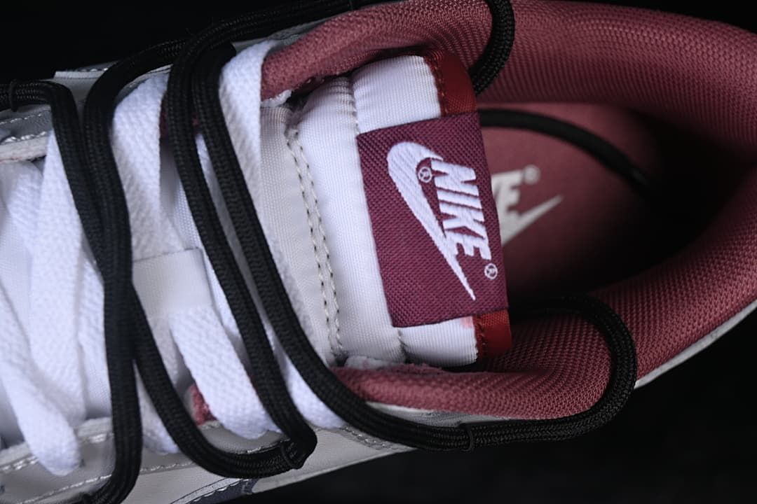 Close-up of tongue label, white laces, and burgundy lining