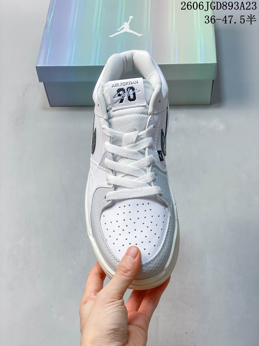 Front view of a Jordan Stadium 90 sneaker showing its perforated toe and lace-up design.