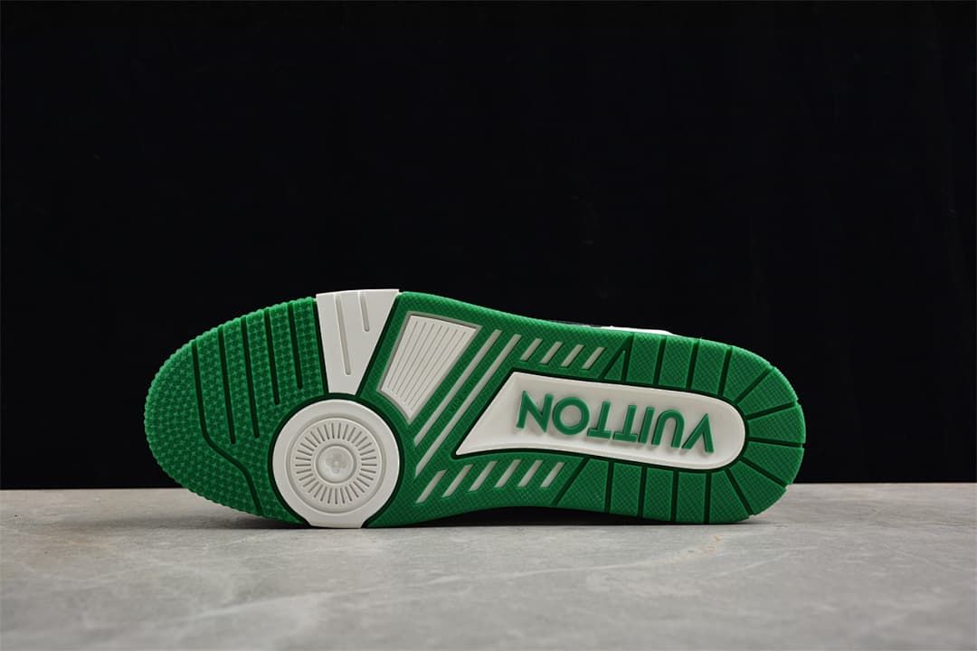 Underside of the sneaker showing the green and white outsole pattern.