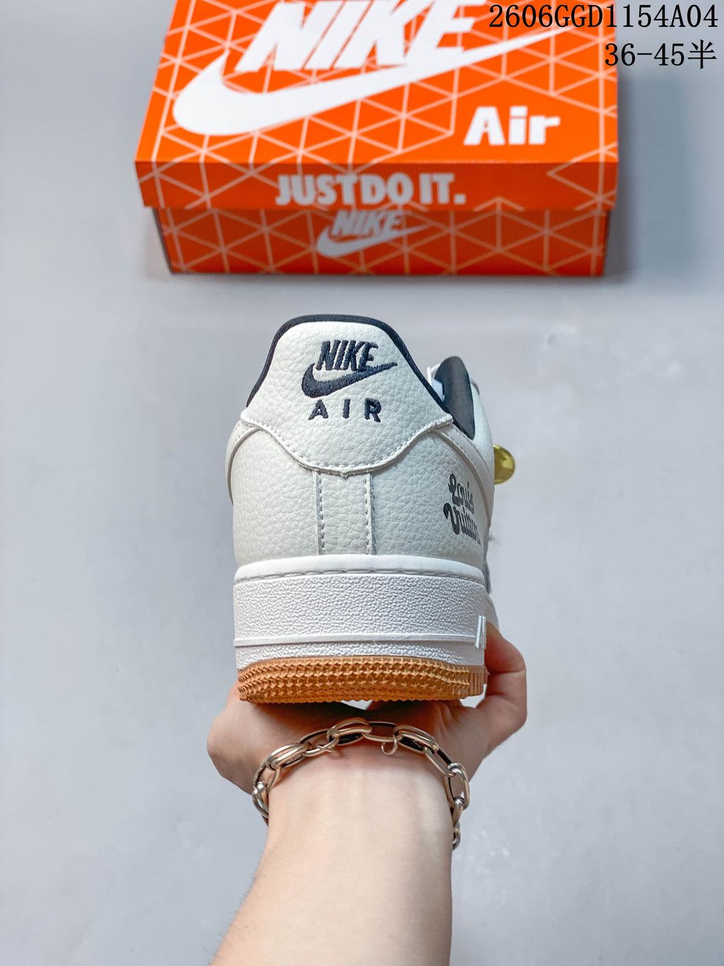 Rear view showing the white heel, dark logo details, and gum-colored outsole.