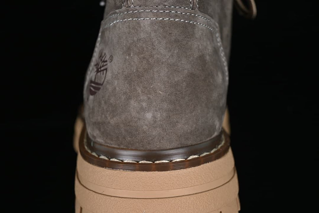 Rear detail of the gray boot, stitching and tan sole.
