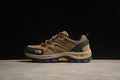 Side view of a sand and brown low-cut outdoor shoe with black and yellow accents