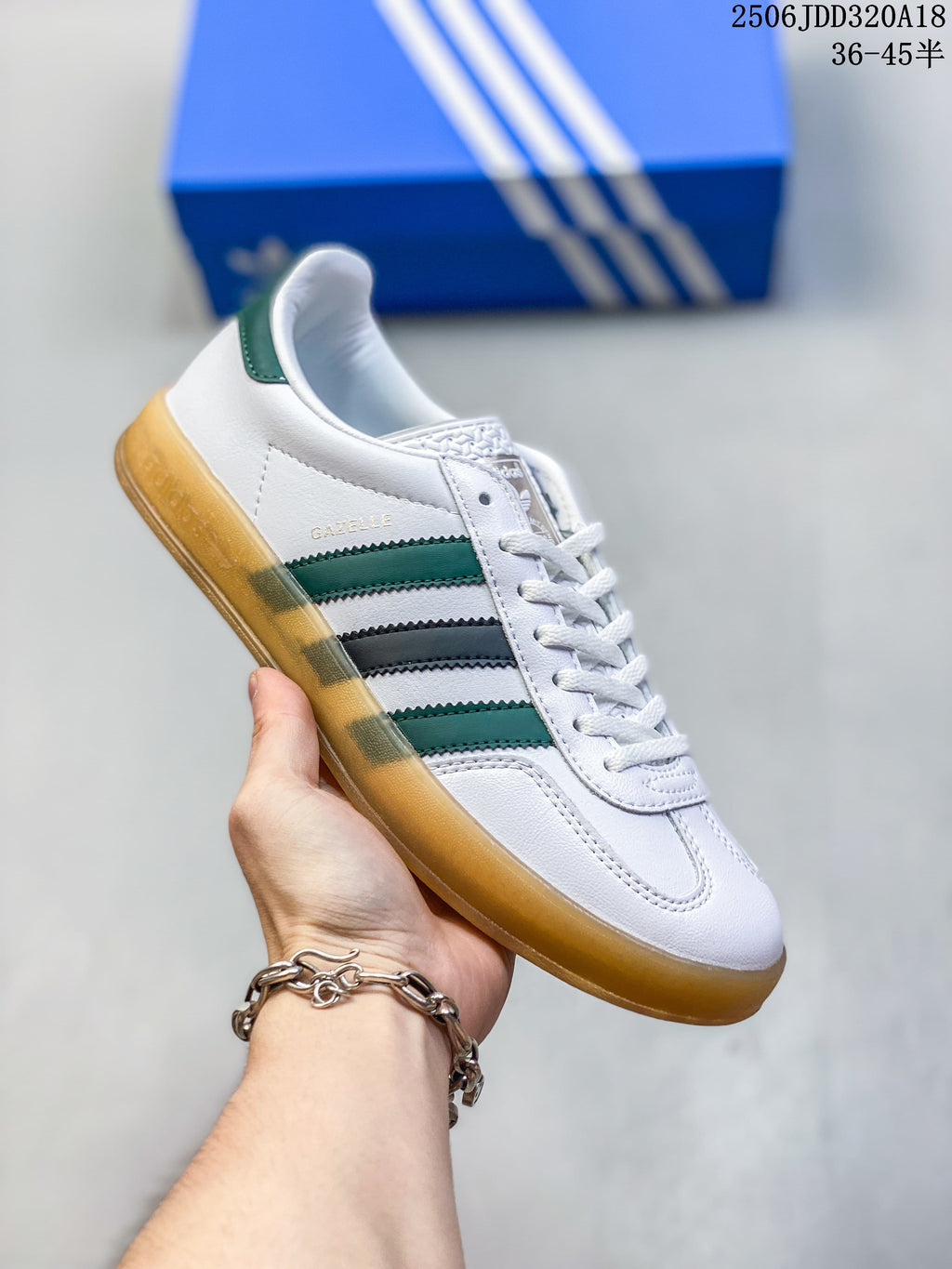White Adidas Gazelle low-top sneaker with green and dark stripes