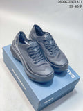 Pair of gray Salomon Phantasm low-top sneakers displayed on a blue shoe box