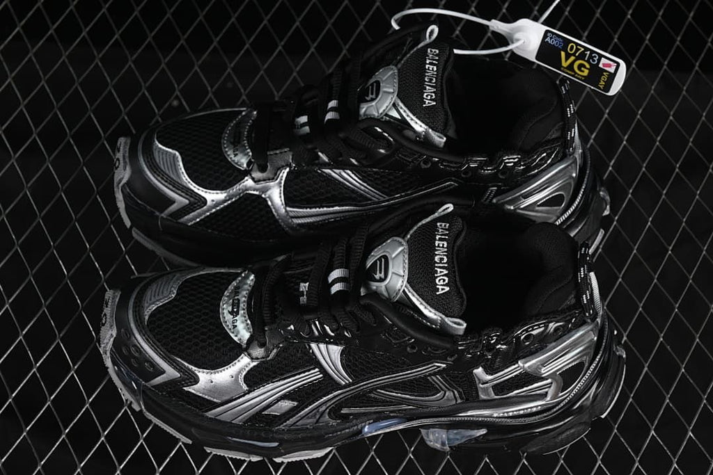 Pair of black and silver sneakers shown from above at an angle.