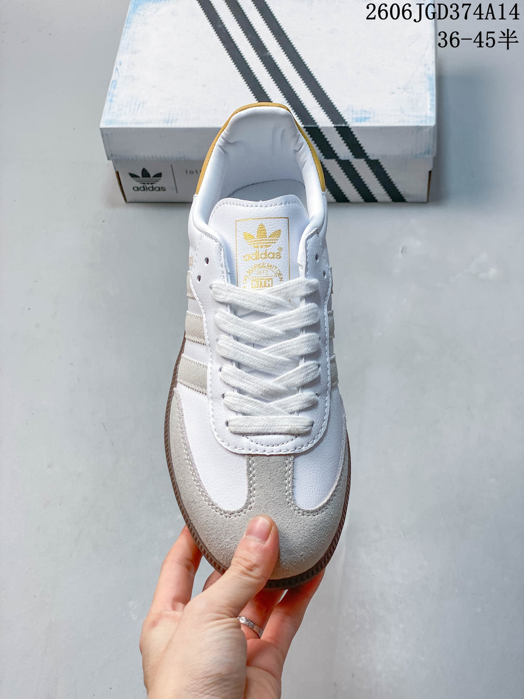 Top view of the lace-up sneaker showing its gray toe overlays and gold tongue branding