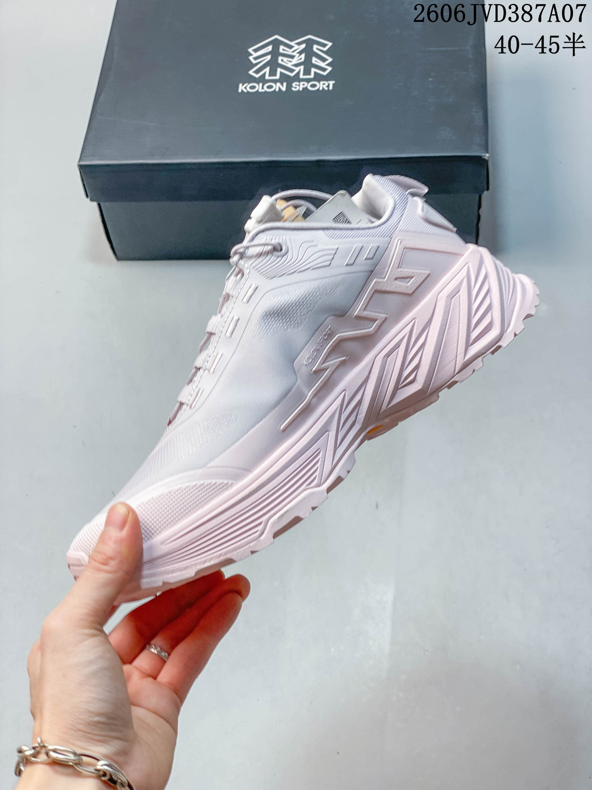 Side profile of a pale gray and pink Kolon Sport sneaker
